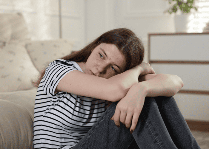 Teenage girl looking unhappy in need of youth suicide prevention Washington