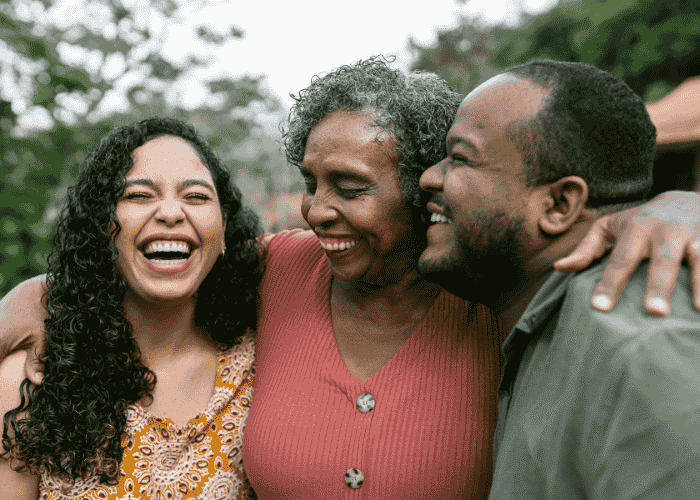 Woman with her parents laughing and smiling due to receiving treatment for cognitive bias vs cognitive distortion