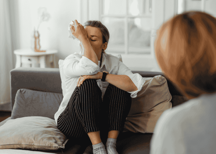 Woman in therapy session after overcoming barriers to mental health care