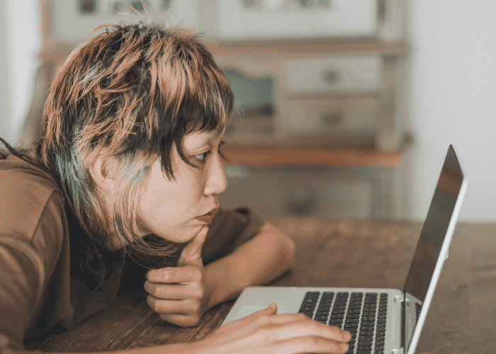 Person staring at a laptop needing support to prevent digital burnout