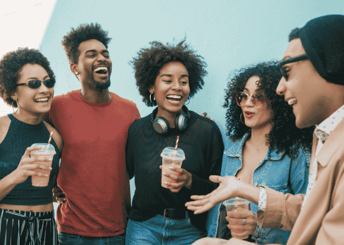 Group of friends laughing and smiling after experiencing state level reform in behavioral health care
