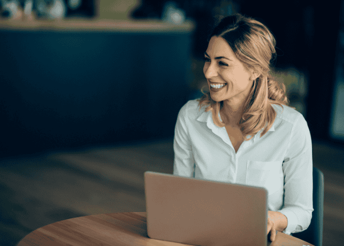 Woman smiling after getting treatment for burnout vs clinical depression in professionals