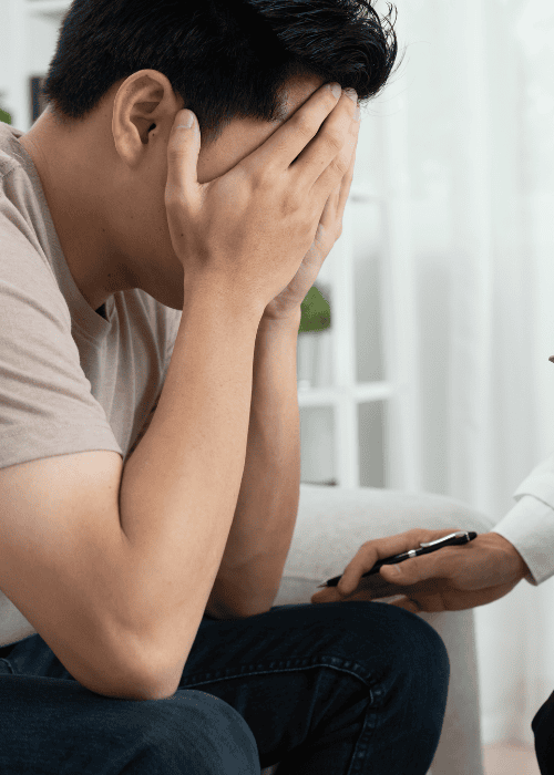 Man in therapy session being supported by practitioner who is aware of legal protections for mental health patients