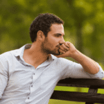 Man sitting on bench in park worrying about therapist strikes