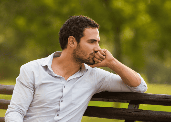 Man sitting on bench in park worrying about therapist strikes