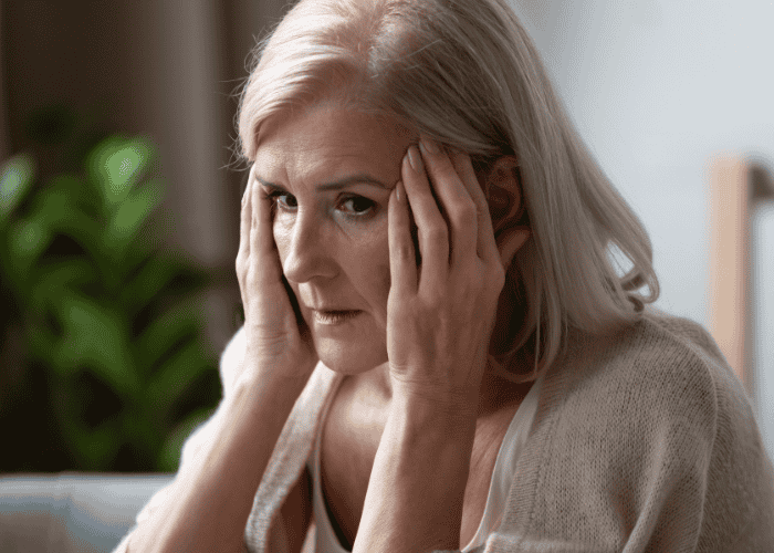 Woman looking anxious with hands on face due to experiencing rejection sensitive dysphoria