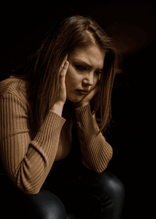 Woman with her head in her hands experiencing when work stress requires clinical intervention
