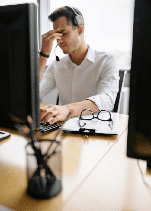 Man at work looking stressed due to workplace stigma