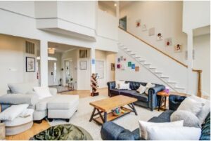 Welcoming common area at a Mission Connection location with soft seating arranged for conversation, high ceilings, and curated artwork.