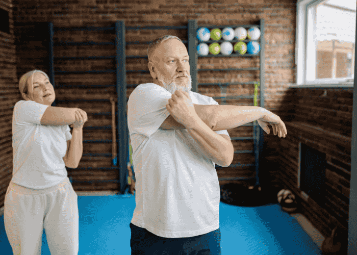 Man and woman in home gym stretching after support with lifestyle psychiatry approach to mental health