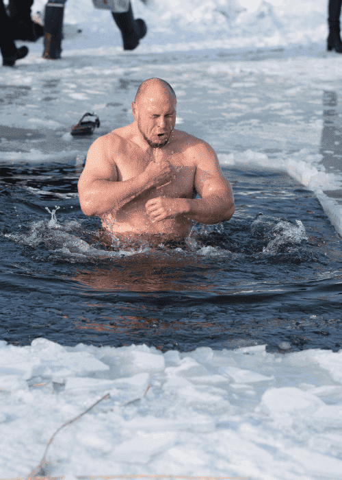 Man taking ice plunge after researching cold exposure and mental health