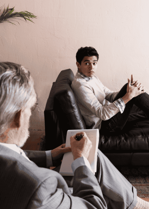 Man looking unhappy in therapy after mental health referrals from legal/government services