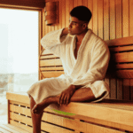 Man sitting in sauna after researching sauna therapy and mental health