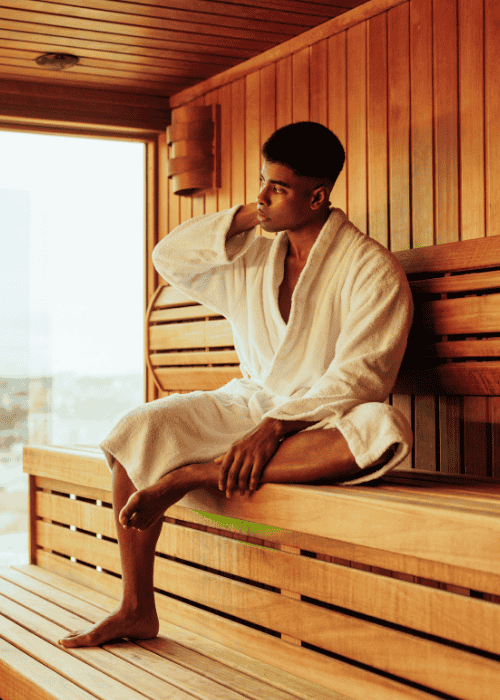Man sitting in sauna after researching sauna therapy and mental health