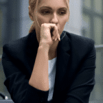 Woman sitting outside office building on step representing amygdala and stress responses