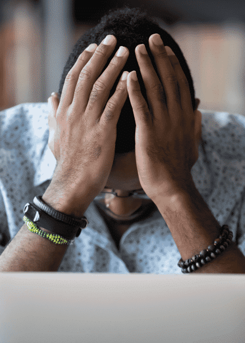 man sitting with head in hands needing help to understand the stress response system