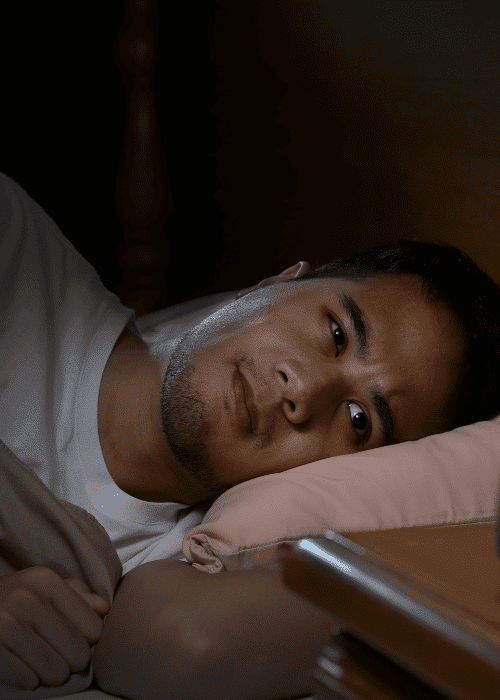 Man lying in bed awake needing support with sleep architecture and mental health