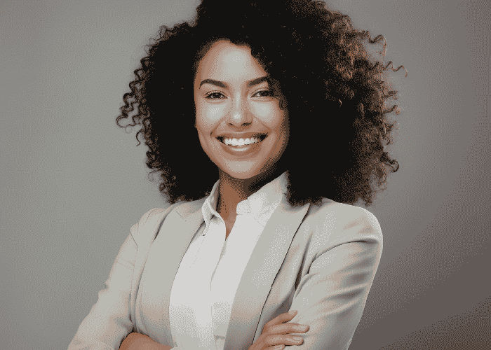 Woman standing with arms crossed smiling after support with dopamine and mood disorders.