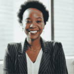 Woman working in office smiling after support with how trauma affects the nervous system