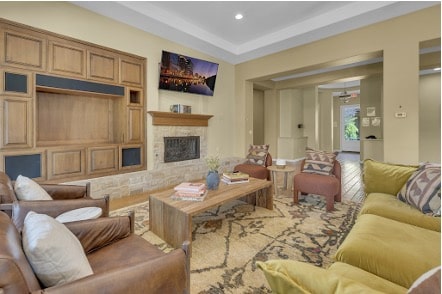 Warm, home-like lounge at a Mission Connection outpatient facility with leather sofas, stone fireplace, and soft natural lighting.