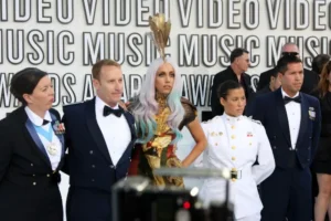Group of people next to Lady Gaga at VMAs