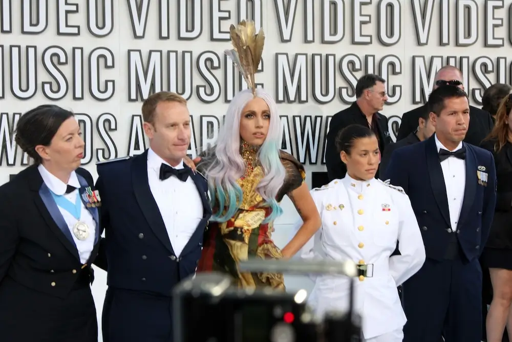 Group of people next to Lady Gaga at VMAs