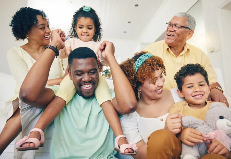 Three generations of family members smiling together
